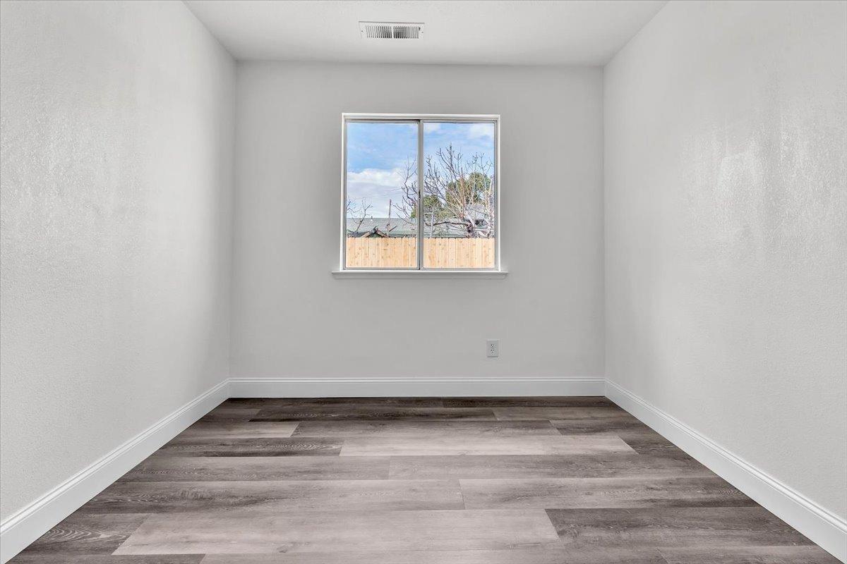 191 Orit Avenue Parlier, CA 93648 - Photo 14 of 25 a view of empty room with wooden floor and fan