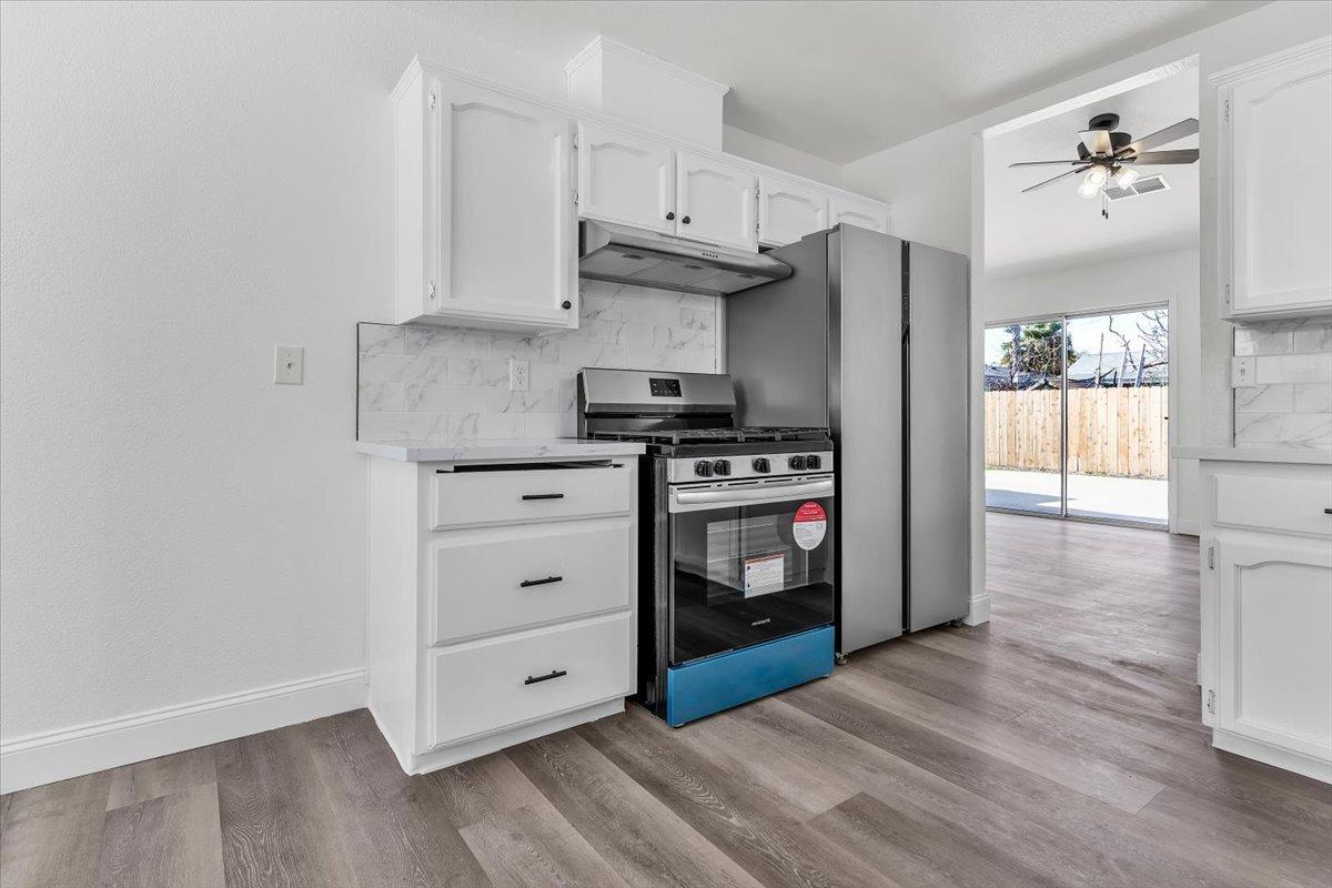 191 Orit Avenue Parlier, CA 93648 - Photo 20 of 25 a kitchen with stainless steel appliances a stove and a refrigerator