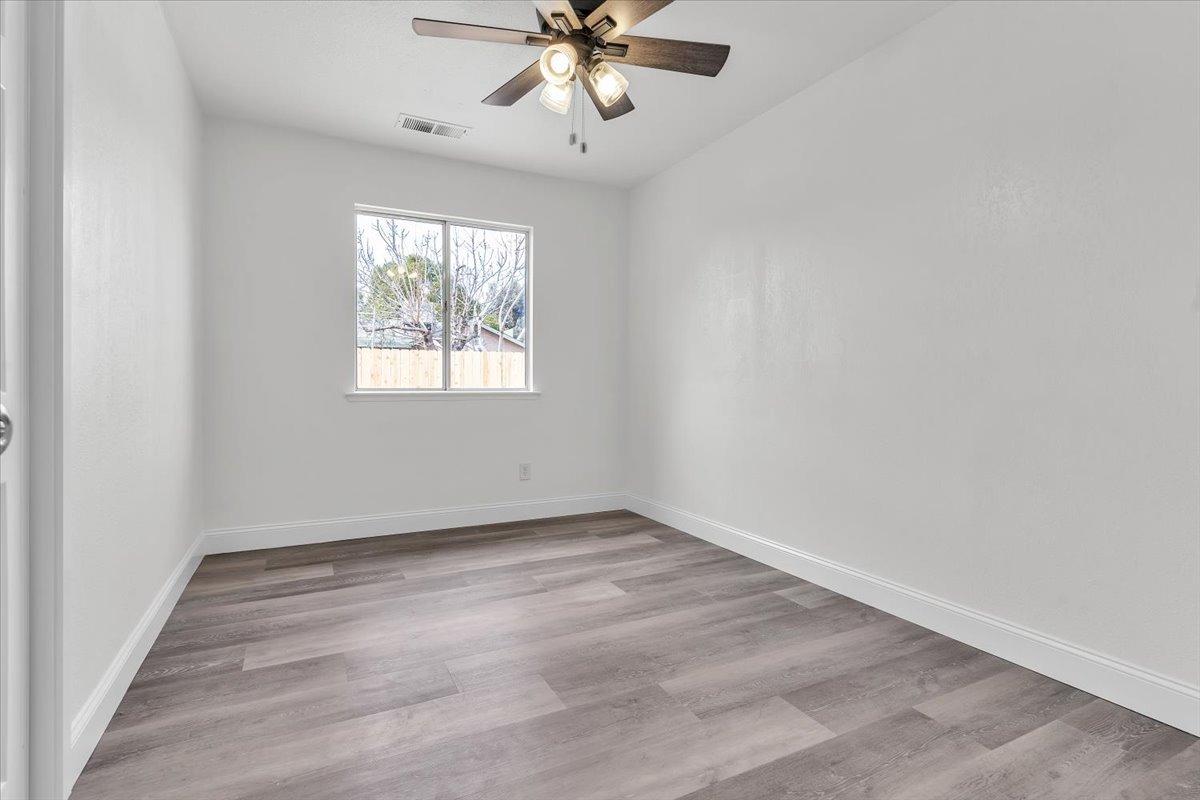 191 Orit Avenue Parlier, CA 93648 - Photo 4 of 25 wooden floor in an empty room with a window