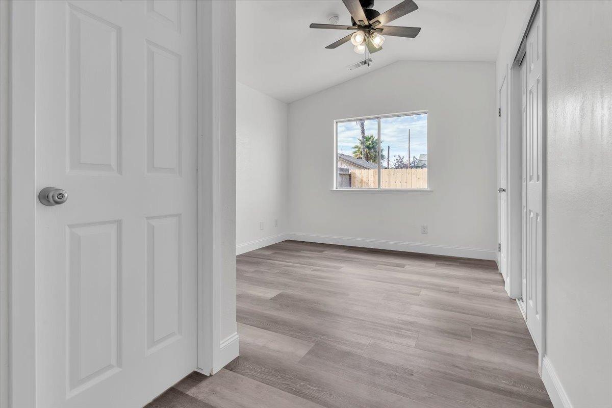191 Orit Avenue Parlier, CA 93648 - Photo 6 of 25 wooden floor in an empty room with a window