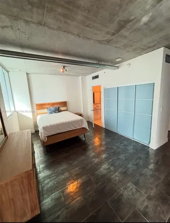 a bedroom with a bed and a mirror