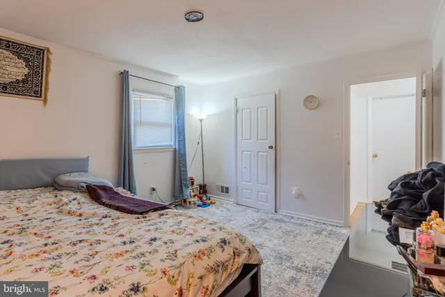 a bedroom with a bed and a mirror