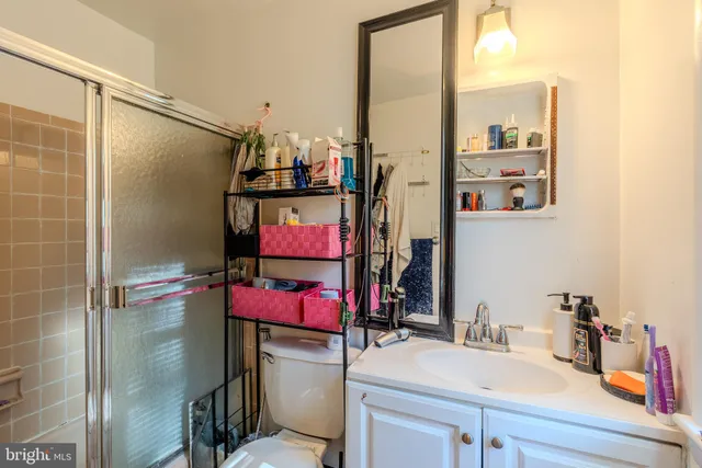 a bathroom with a sink vanity mirror and toilet