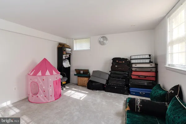 a living room with furniture a air conditioner and a window