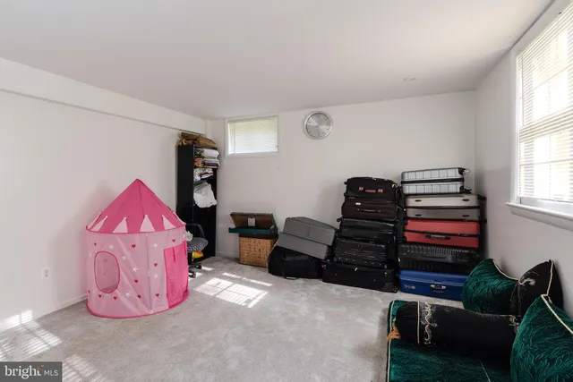 a living room with furniture a air conditioner and a window