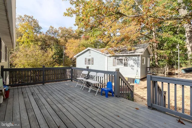 a view of a house with wooden deck