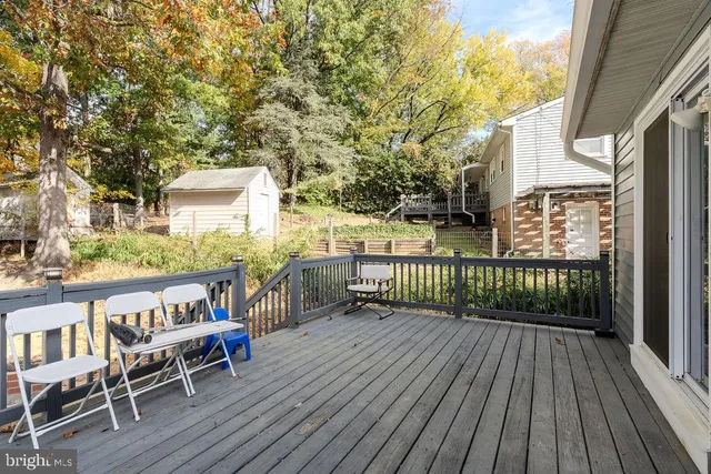 a view of a balcony with wooden floor and outdoor seating