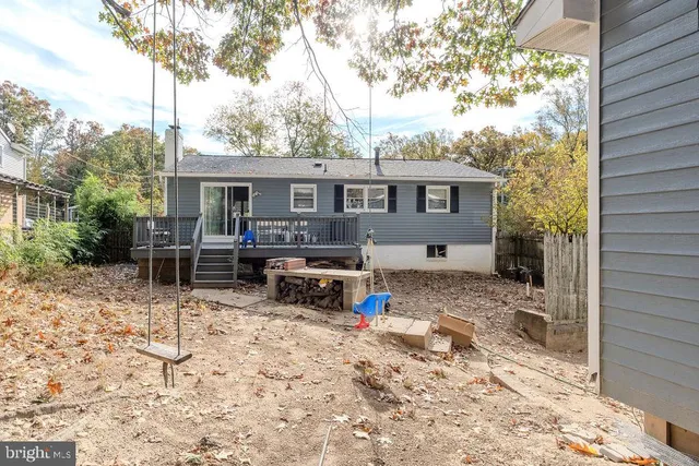 a view of a house with a yard and sitting area