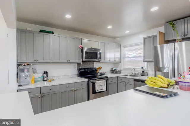 a kitchen with stainless steel appliances granite countertop a stove refrigerator sink and cabinets