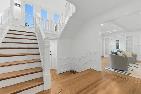 a view of entryway and hall with wooden floor