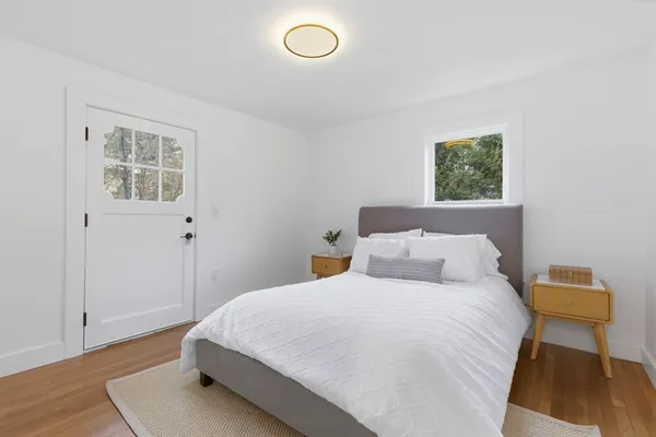 a bedroom with a bed and wooden floor