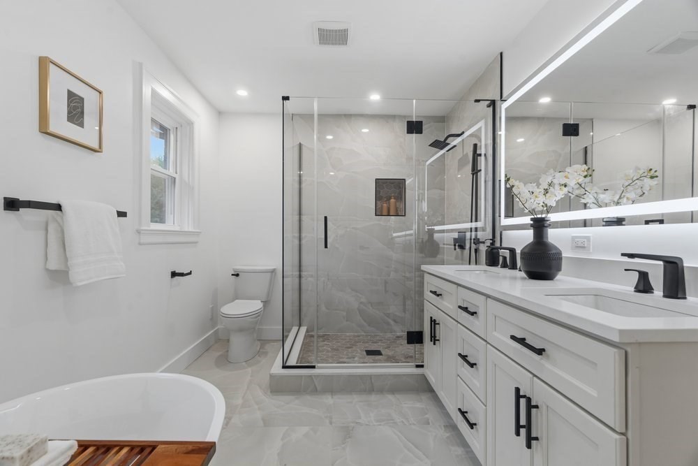 1806 Beacon Street Newton, MA 02468 - Photo 20 of 38 a bathroom with a double vanity sink toilet mirror and shower