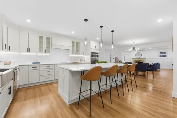 a large kitchen with lots of counter space and furniture