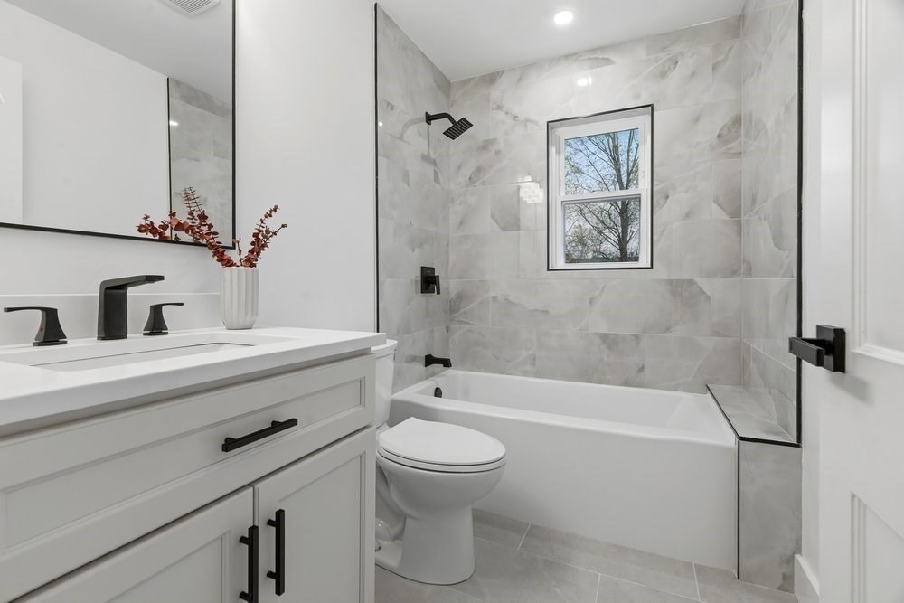 1806 Beacon Street Newton, MA 02468 - Photo 23 of 38 a bathroom with a sink a toilet and a bathtub