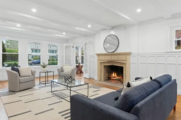 a living room with furniture a window and a fireplace