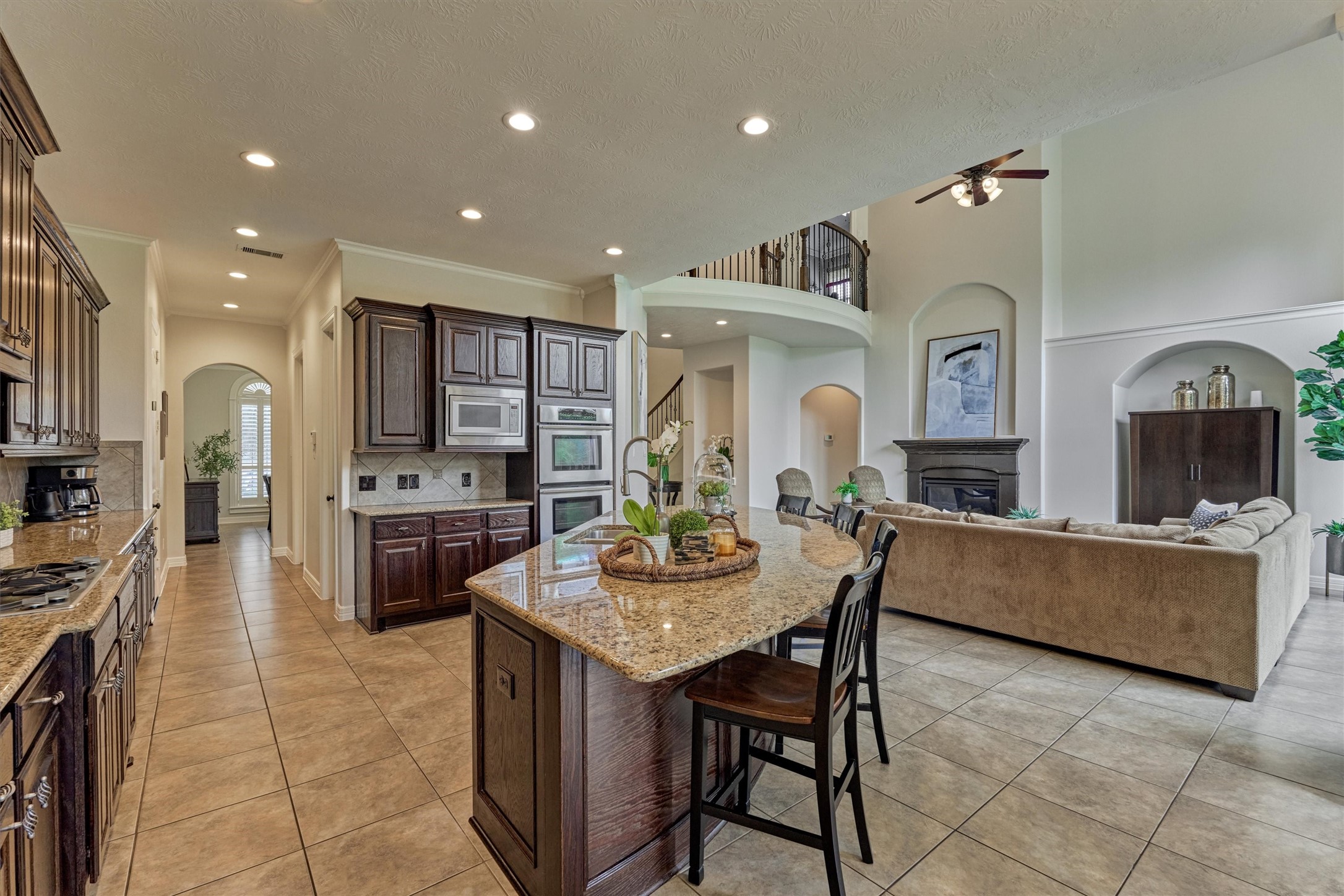 67 South Sage Sparrow Circle Spring, TX 77389 - Photo 22 of 49 a living room with fireplace furniture and kitchen view