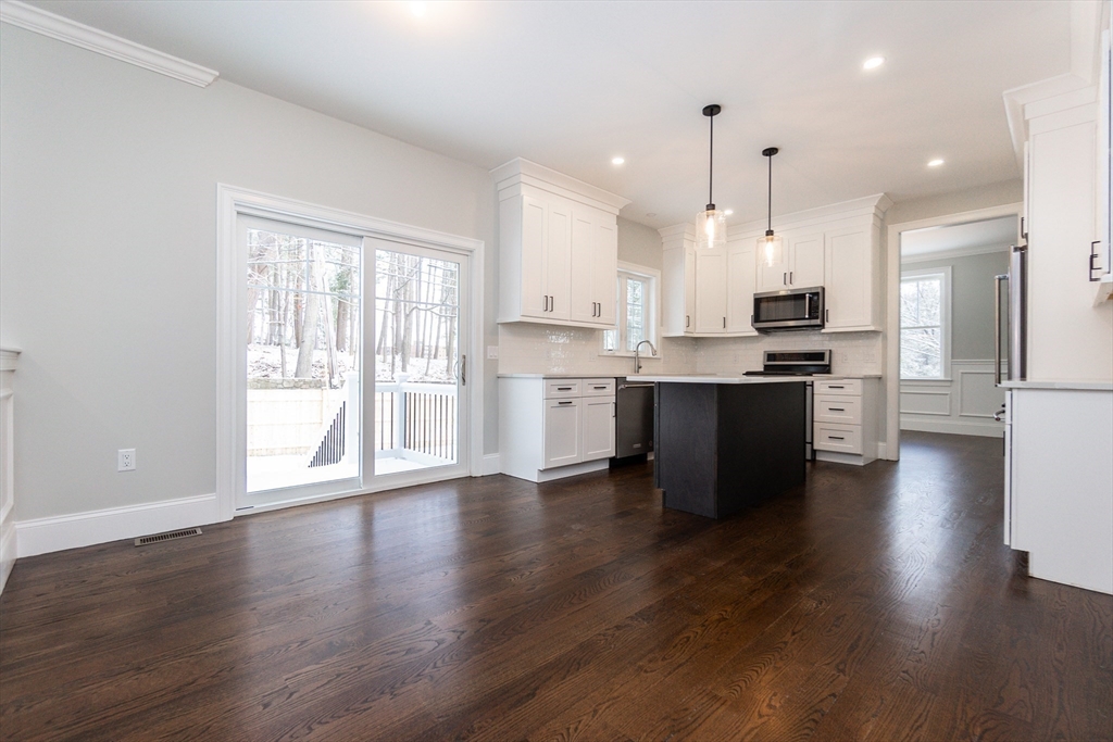 601 Salem End Road Framingham, MA 01702 - Photo 19 of 42 a view of kitchen with wooden floor and window