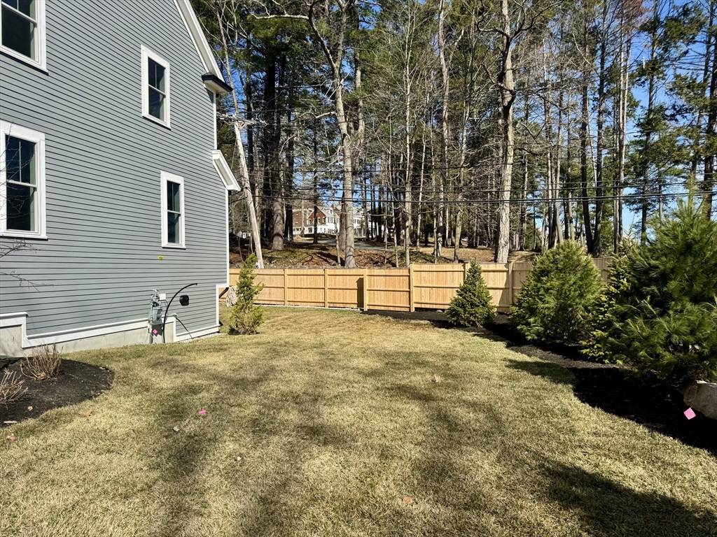 601 Salem End Road Framingham, MA 01702 - Photo 6 of 42 a backyard of a house with a yard and garage