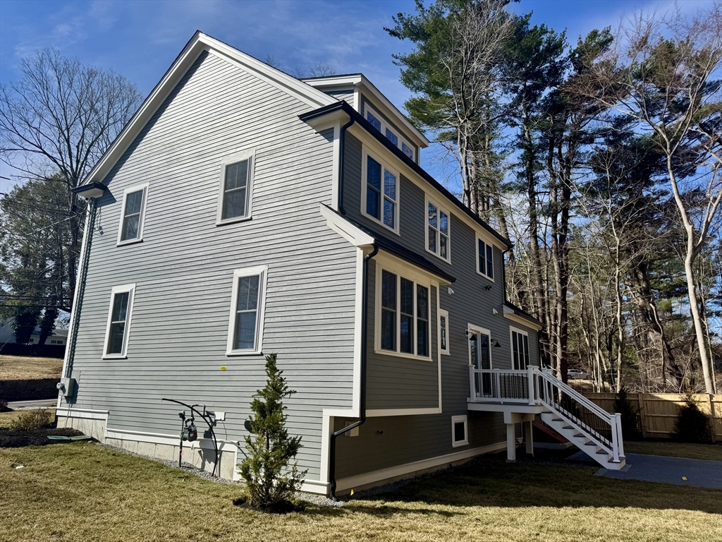 601 Salem End Road Framingham, MA 01702 - Photo 7 of 42 a backyard of a house with lots of trees and plants
