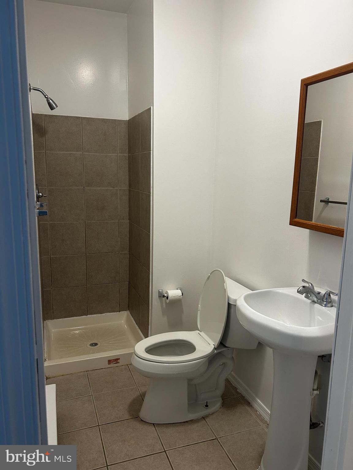 29 North Main Street, Unit 2E Spring City, PA 19475 - Photo 10 of 12 a white toilet sitting next to a bathroom sink and a shower