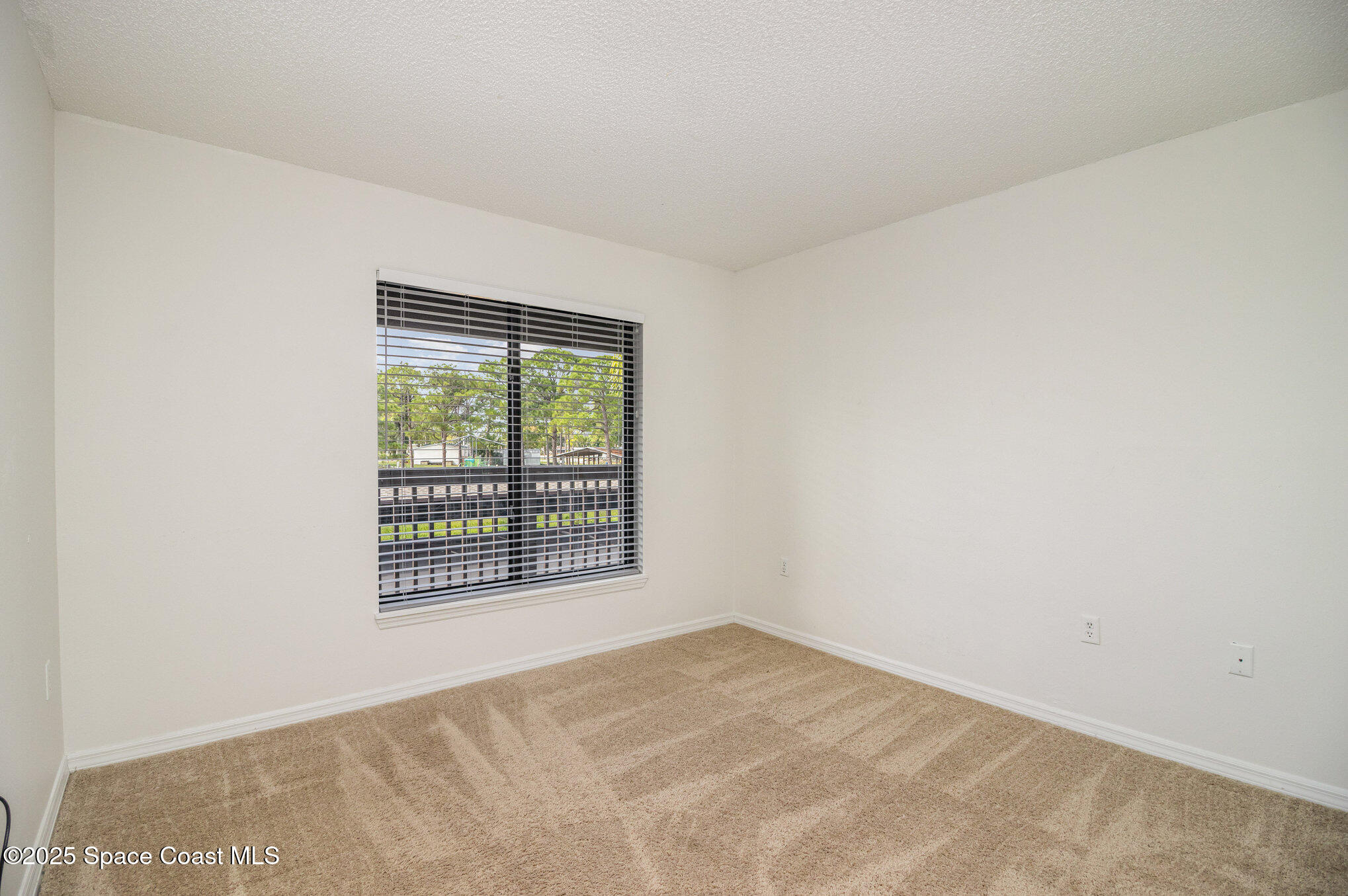 1515 Huntington Lane, Unit 626 Rockledge, FL 32955 - Photo 11 of 14 a view of an empty room with a window