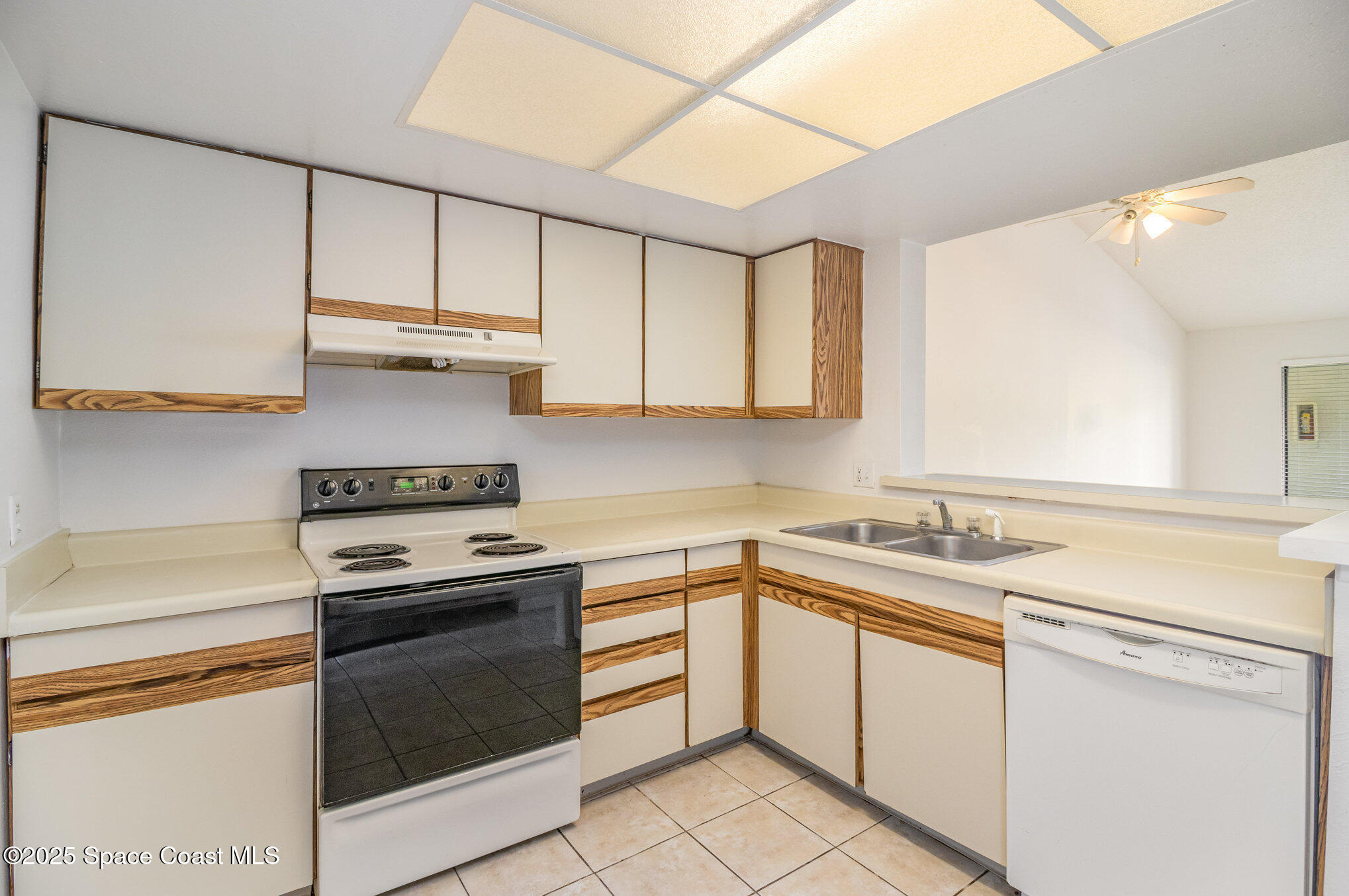 1515 Huntington Lane, Unit 626 Rockledge, FL 32955 - Photo 5 of 14 a kitchen with cabinets appliances a sink and a counter top space