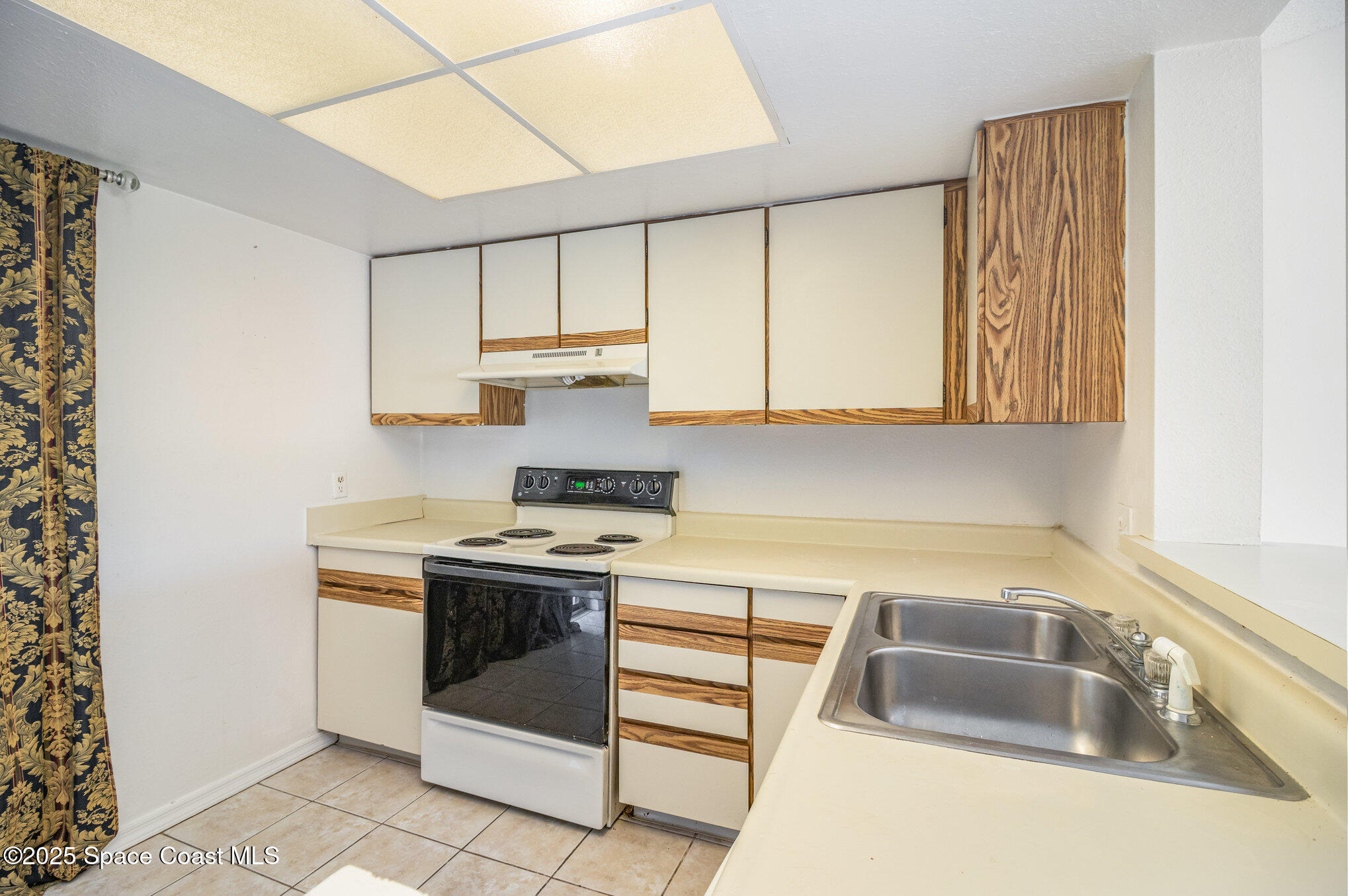 1515 Huntington Lane, Unit 626 Rockledge, FL 32955 - Photo 6 of 14 a kitchen with a stove sink and cabinets