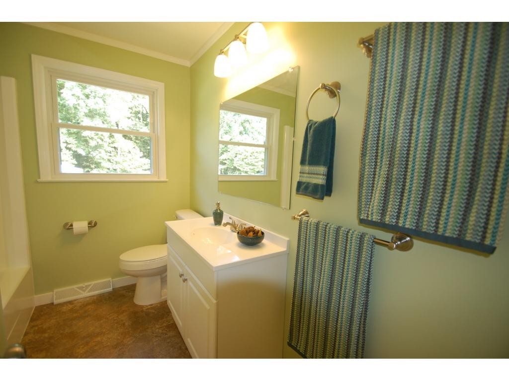 401 Lancaster Road Mebane, NC 27302 - Photo 13 of 15 a bathroom with a sink a toilet and a mirror