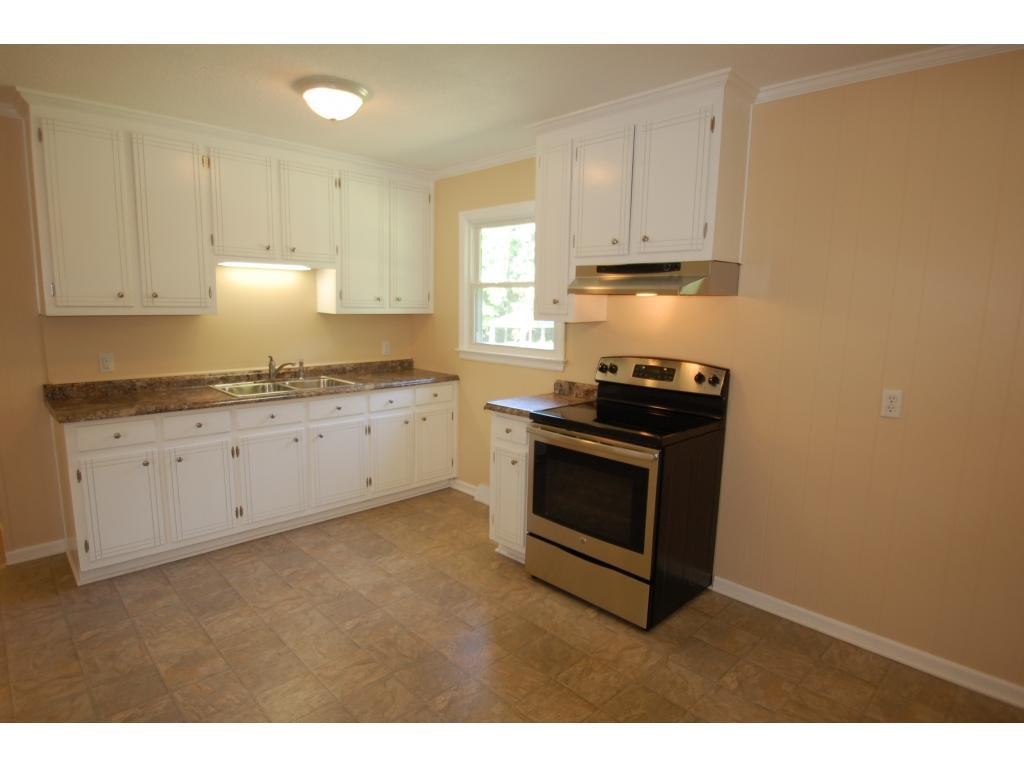 401 Lancaster Road Mebane, NC 27302 - Photo 5 of 15 a kitchen with granite countertop a stove a sink and a granite counter tops