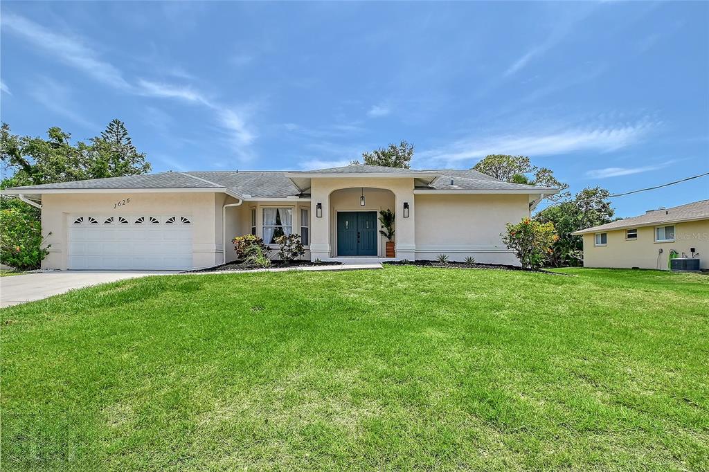 a front view of a house with garden