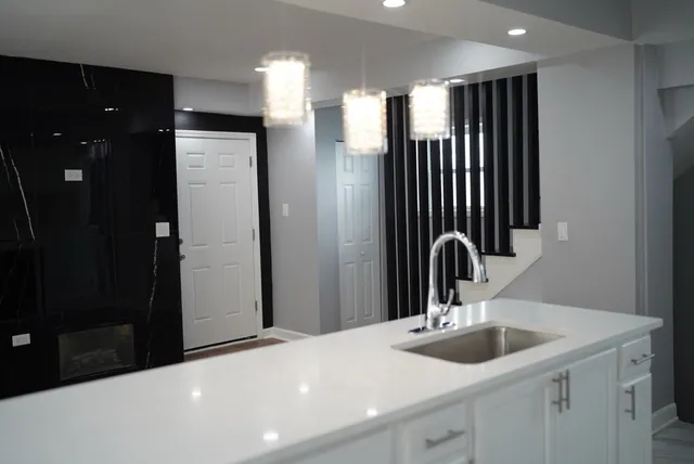 a view of a bathroom with a sink and mirror