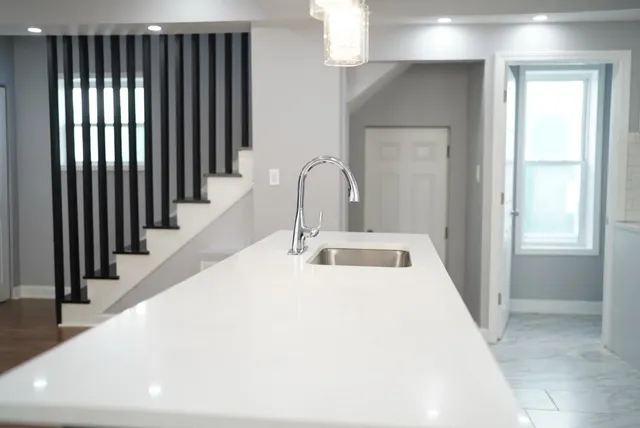 a kitchen with stainless steel appliances a refrigerator a sink a stove a microwave and cabinets