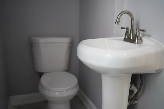 a bathroom with a toilet and a mirror