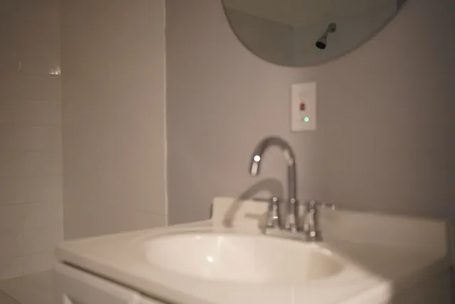 a bathroom with a shower toilet and sink