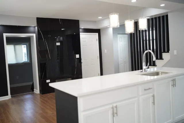 a kitchen with a sink a refrigerator and cabinets