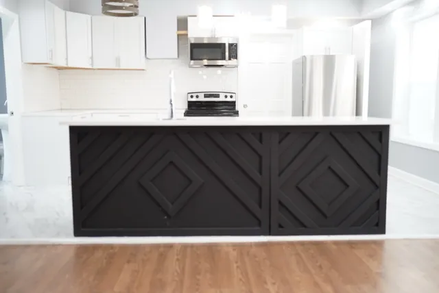 a kitchen with a black white wall