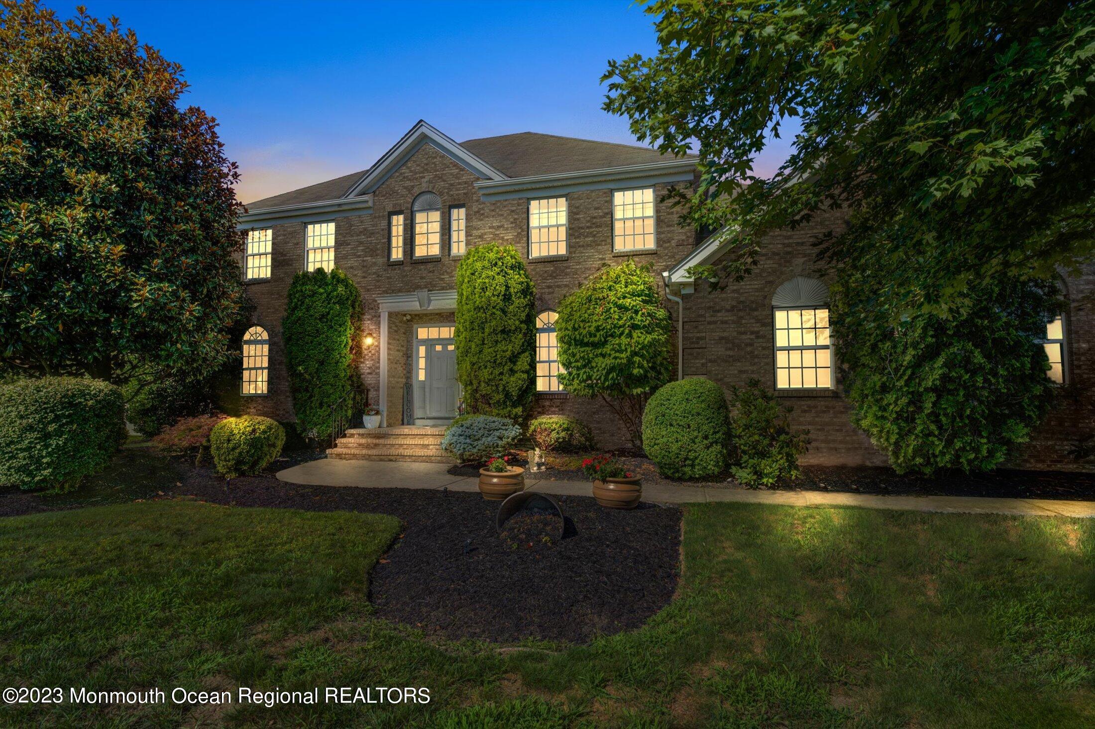 a view of a brick house with a yard