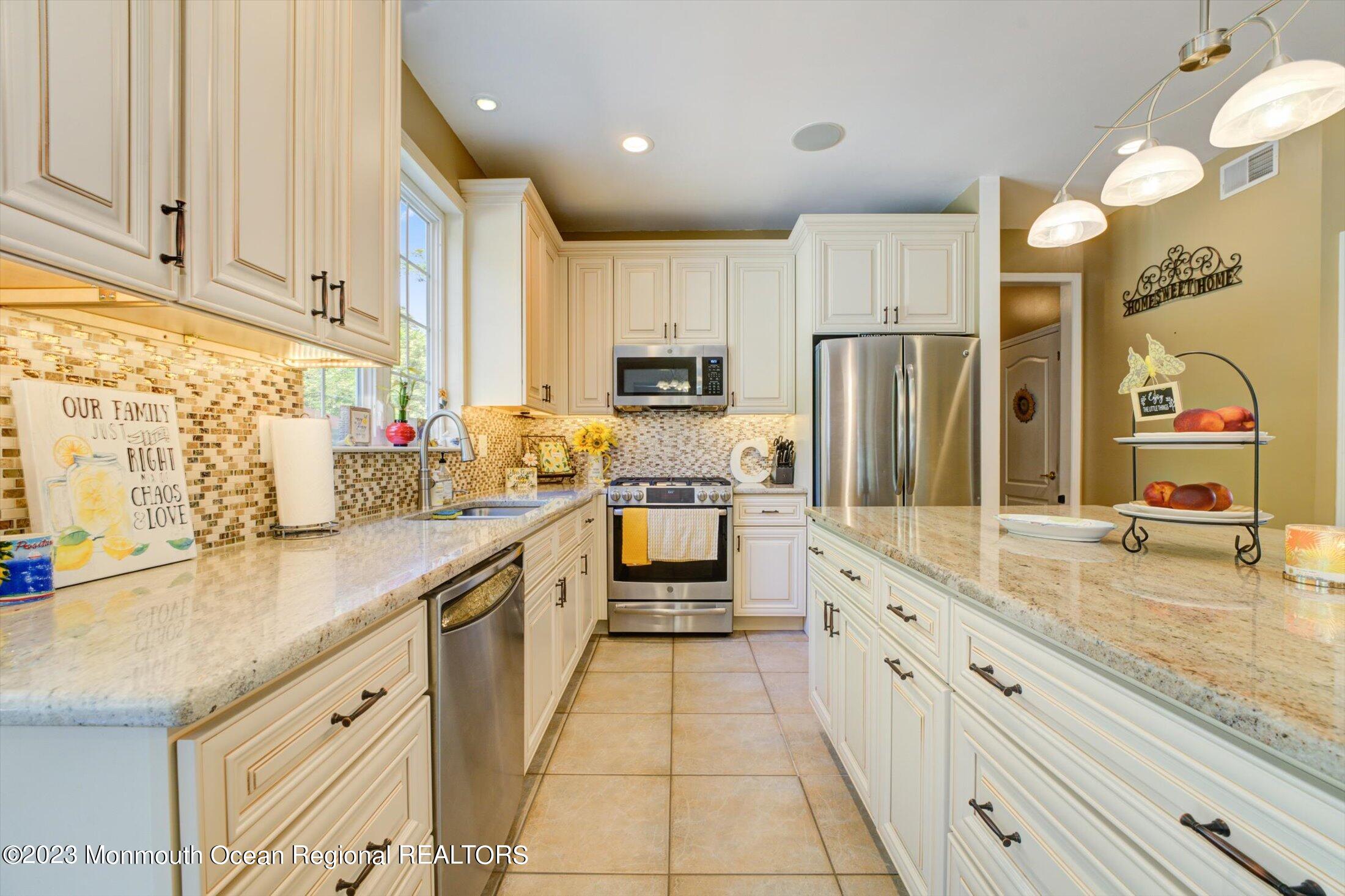 22 Rodeo Drive Jackson, NJ 08527 - Photo 2 of 42 a large kitchen with stainless steel appliances granite countertop a sink and cabinets