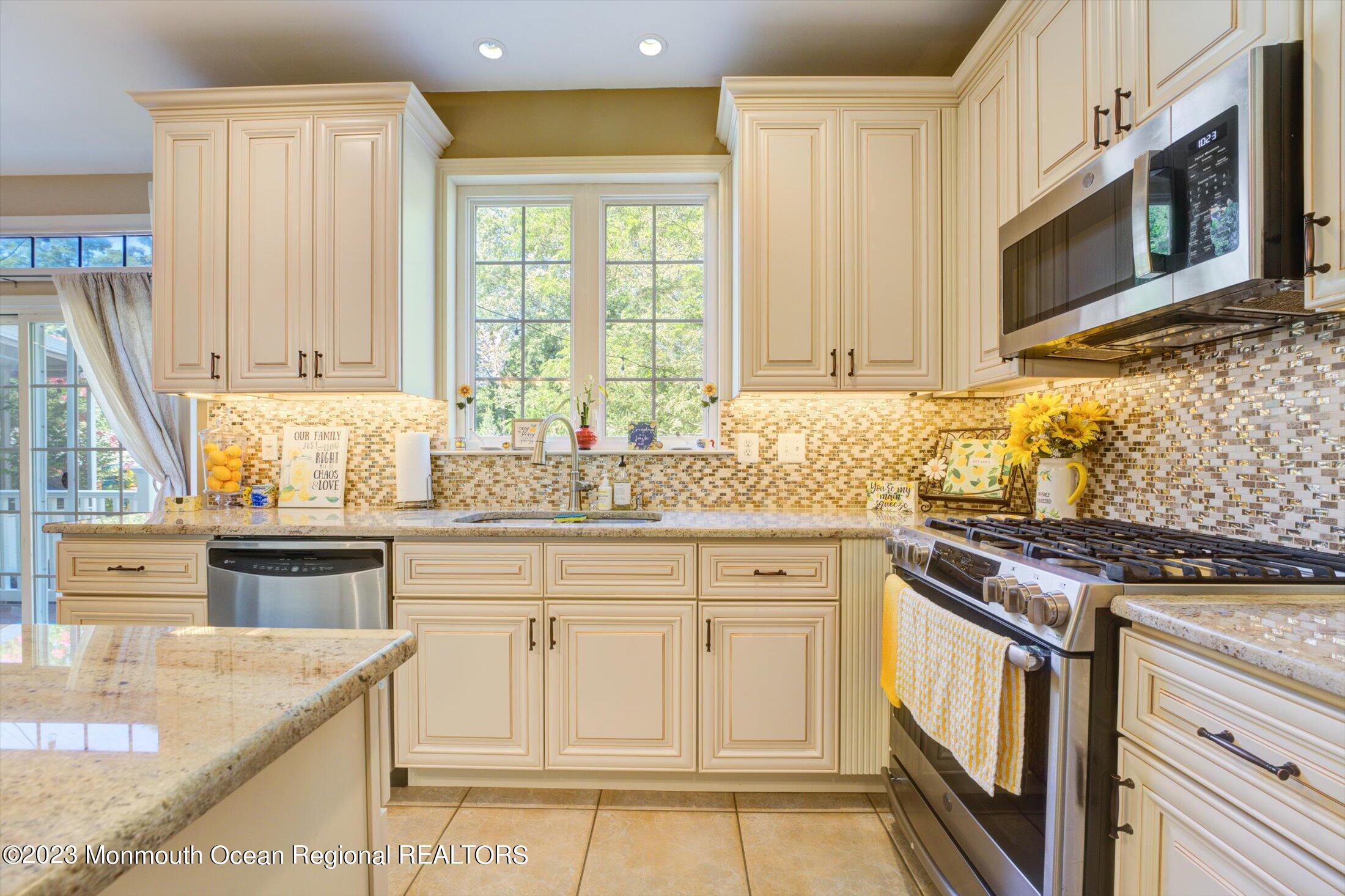 22 Rodeo Drive Jackson, NJ 08527 - Photo 3 of 42 a kitchen with stainless steel appliances granite countertop a stove a sink and a microwave