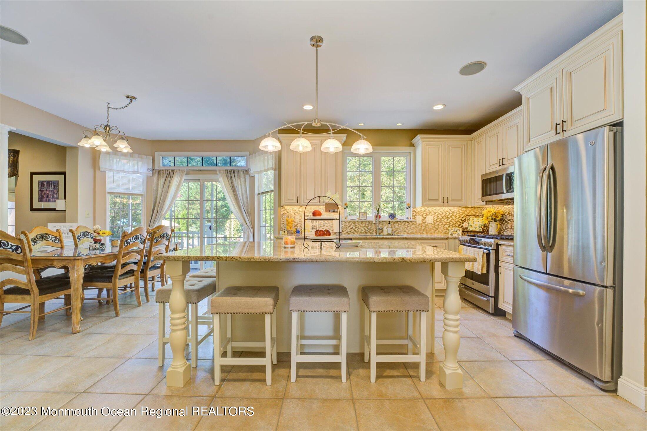 22 Rodeo Drive Jackson, NJ 08527 - Photo 5 of 42 a kitchen with a table chairs refrigerator and cabinets