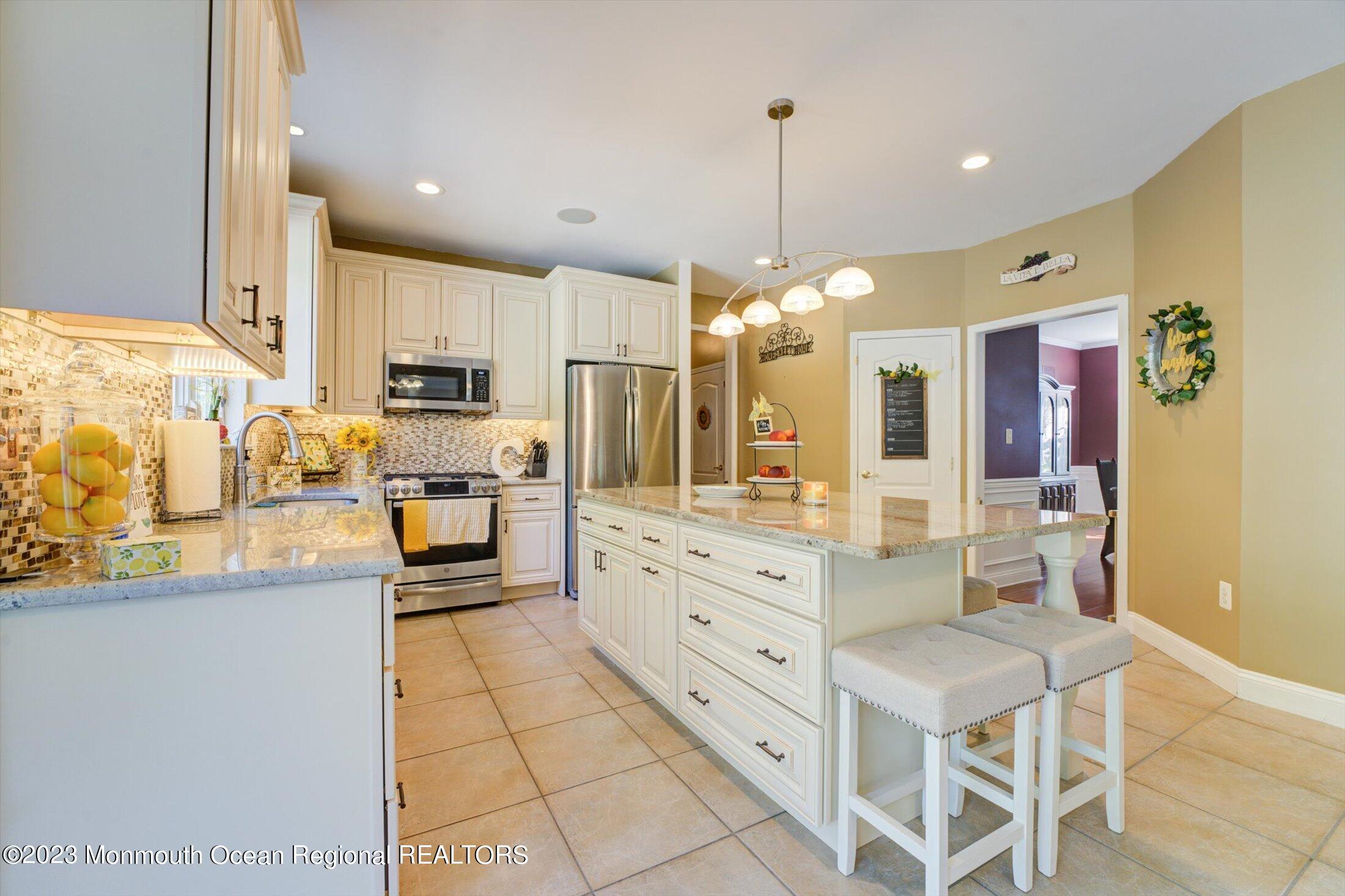 22 Rodeo Drive Jackson, NJ 08527 - Photo 6 of 42 a kitchen with stainless steel appliances kitchen island granite countertop a sink and cabinets