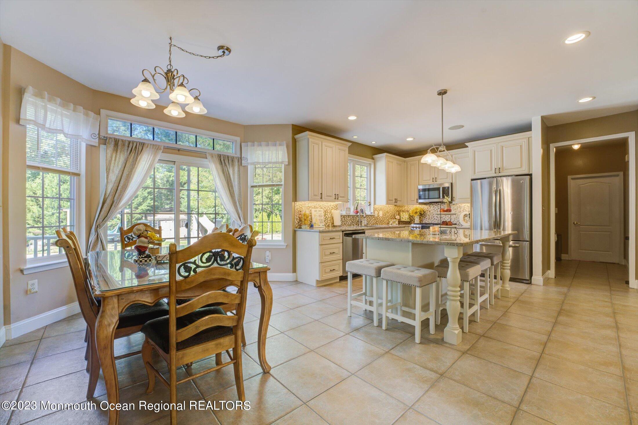 22 Rodeo Drive Jackson, NJ 08527 - Photo 7 of 42 a view of a dining room with furniture window and outside view