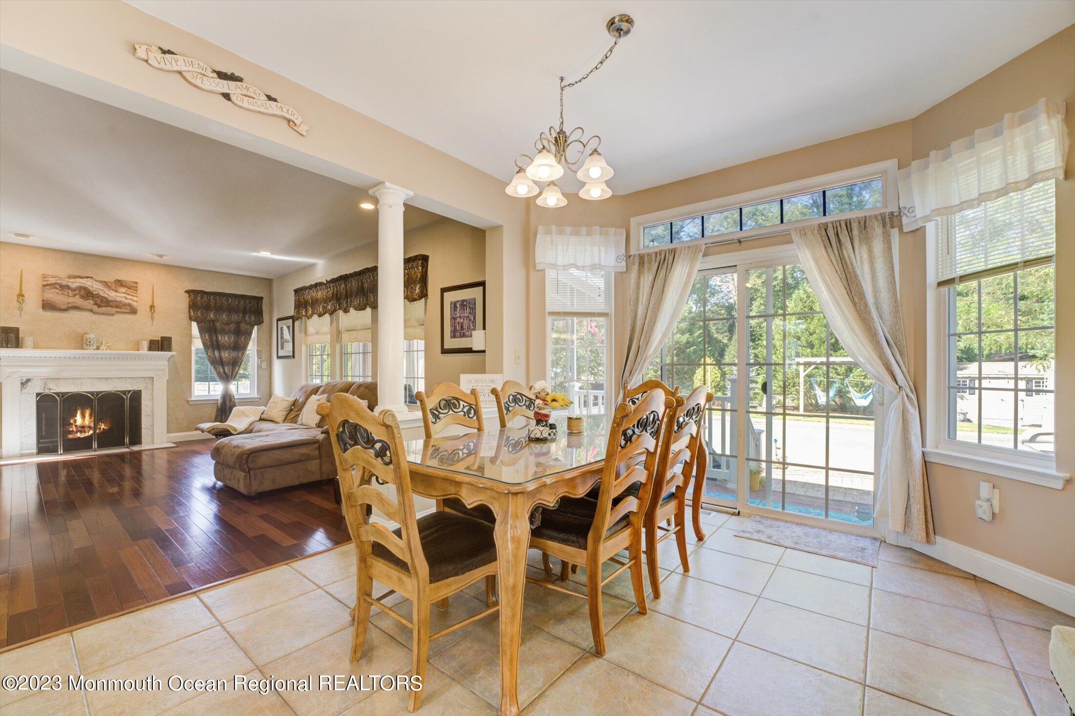 22 Rodeo Drive Jackson, NJ 08527 - Photo 8 of 42 a view of a dining room with furniture wooden floor and chandelier