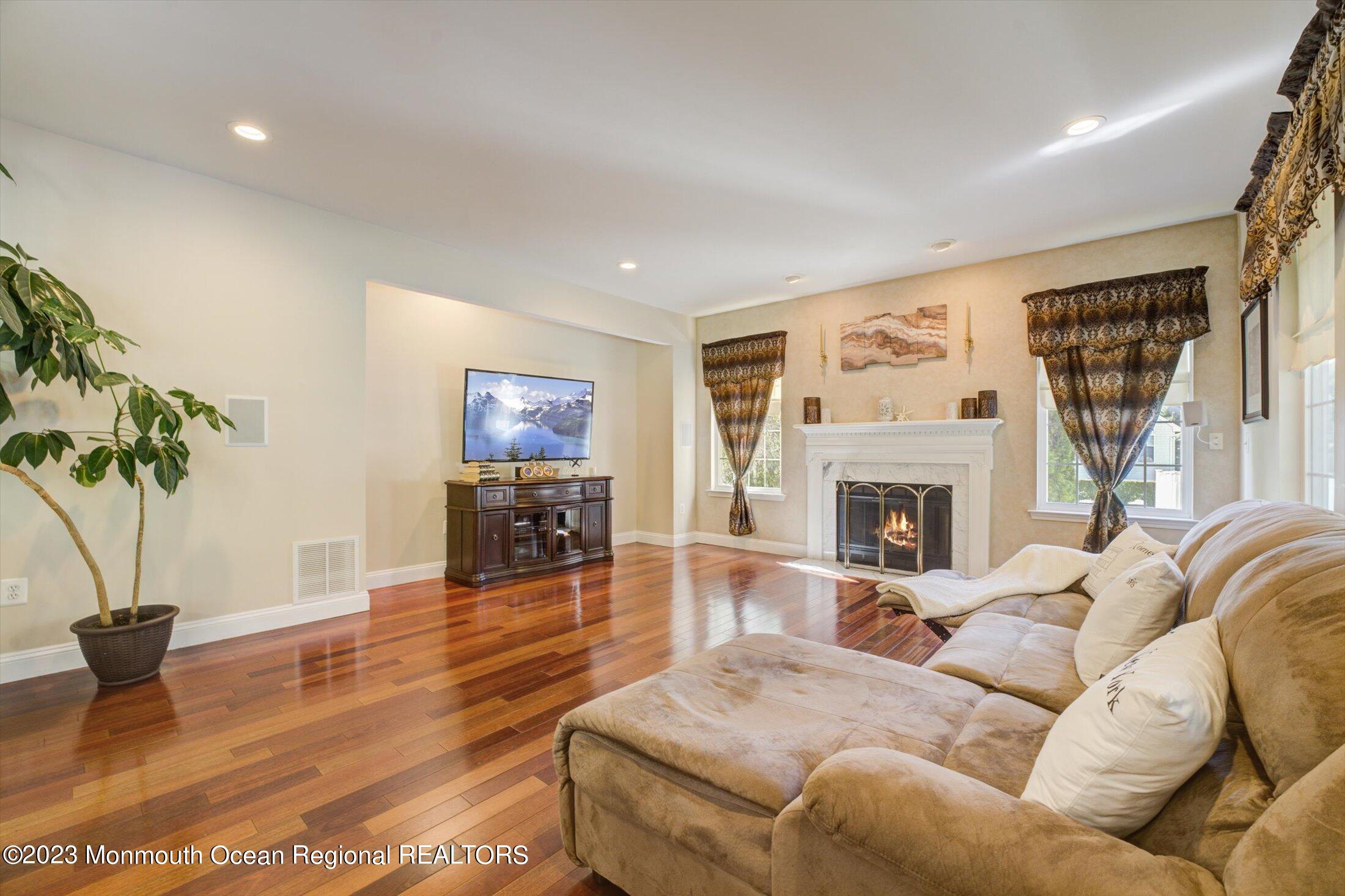 22 Rodeo Drive Jackson, NJ 08527 - Photo 10 of 42 a living room with furniture a fireplace and a potted plant