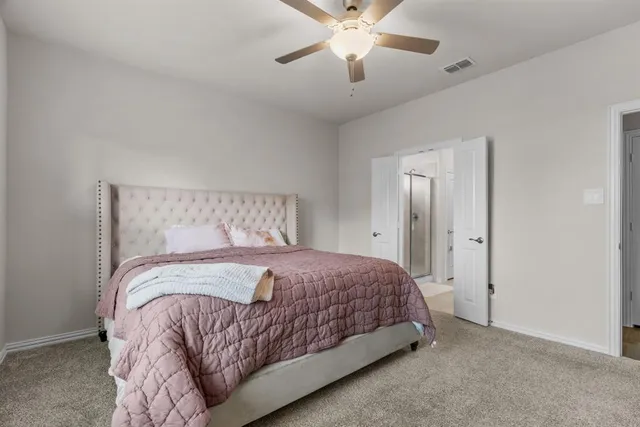 a bed sitting in a bedroom next to a window