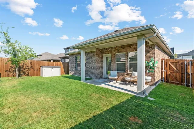 a front view of a house with a yard glass top table and chairs