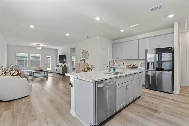 a picture of a bench in room with a white