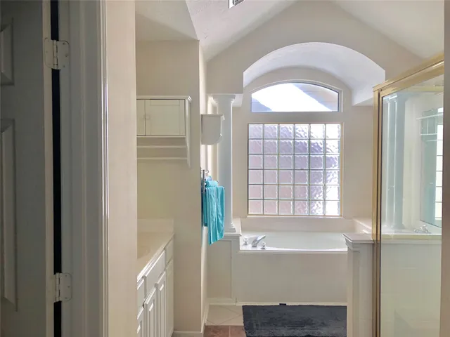 a bathroom with a bathtub and a shower