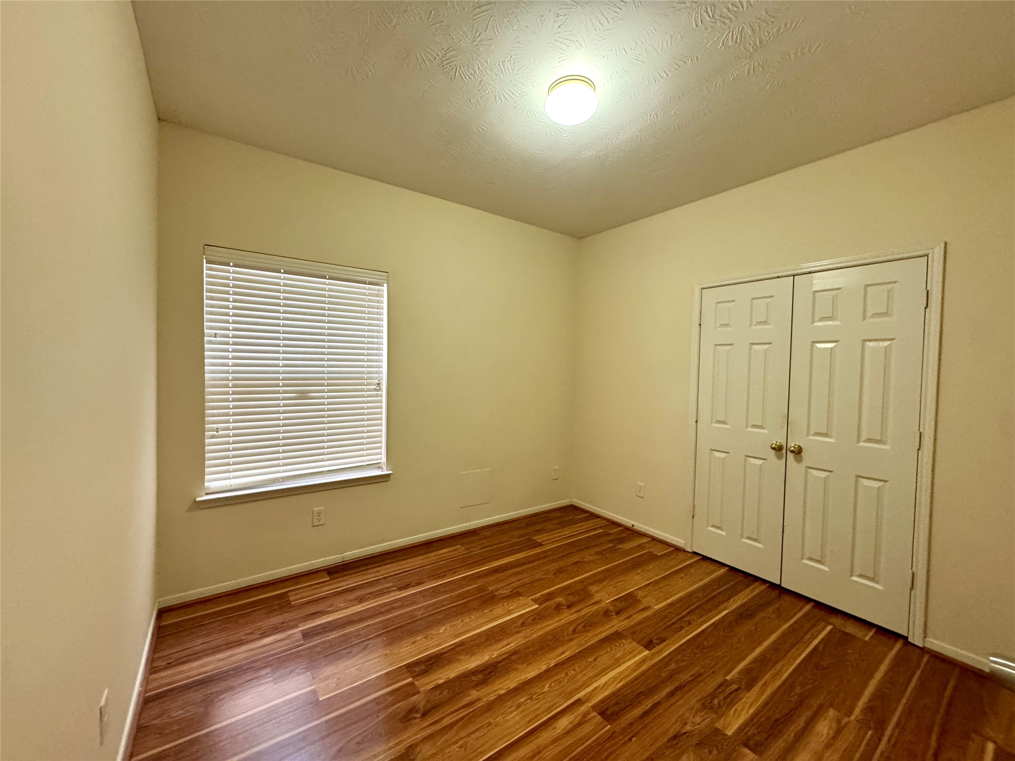 13113 Sunset Cliff Court Sugar Land, TX 77478 - Photo 20 of 22 a view of an empty room with wooden floor and a window