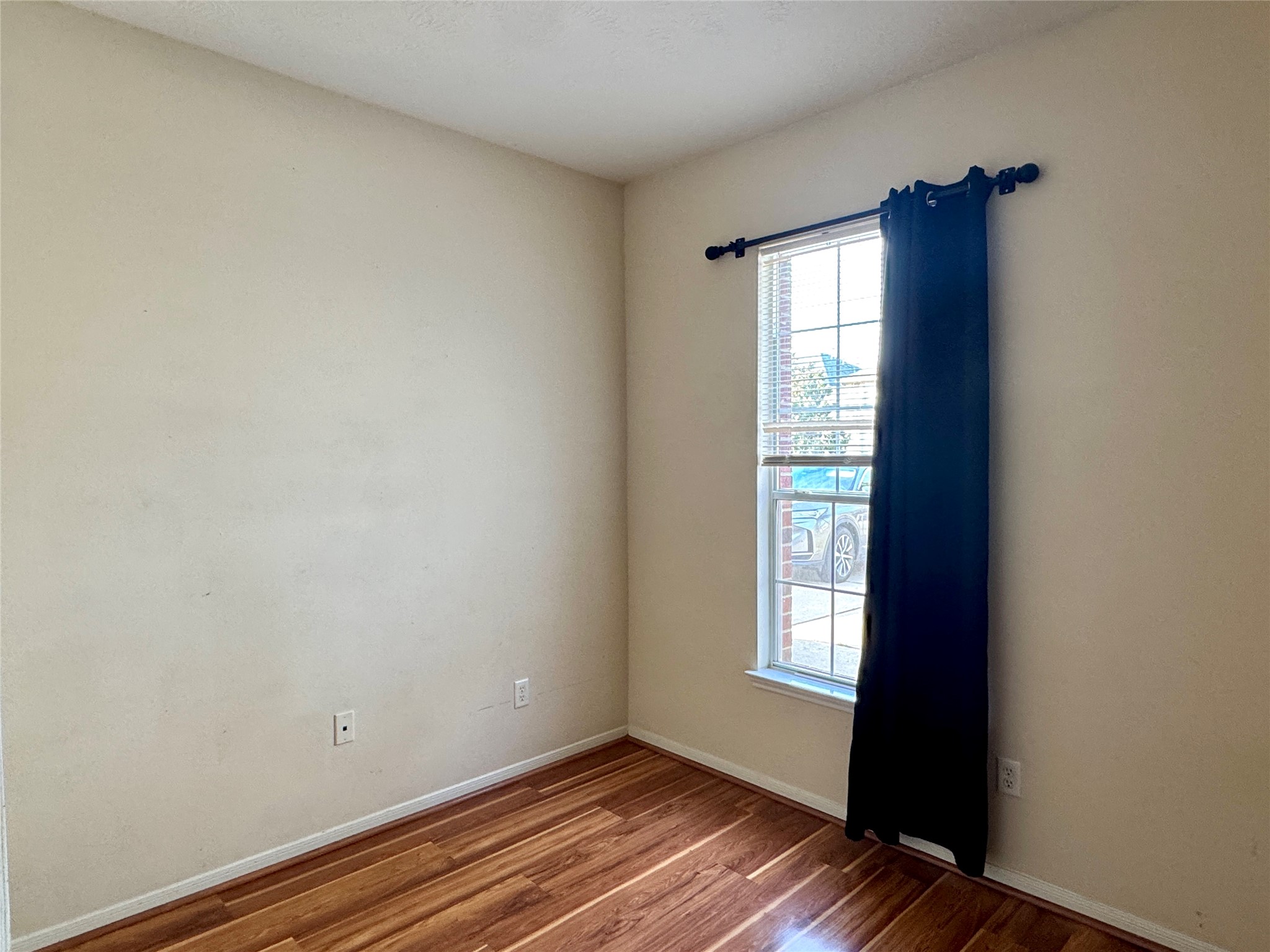13113 Sunset Cliff Court Sugar Land, TX 77478 - Photo 22 of 22 a view of an empty room with wooden floor and a window